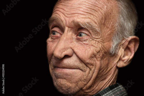 Cheerful elderly man on a black background