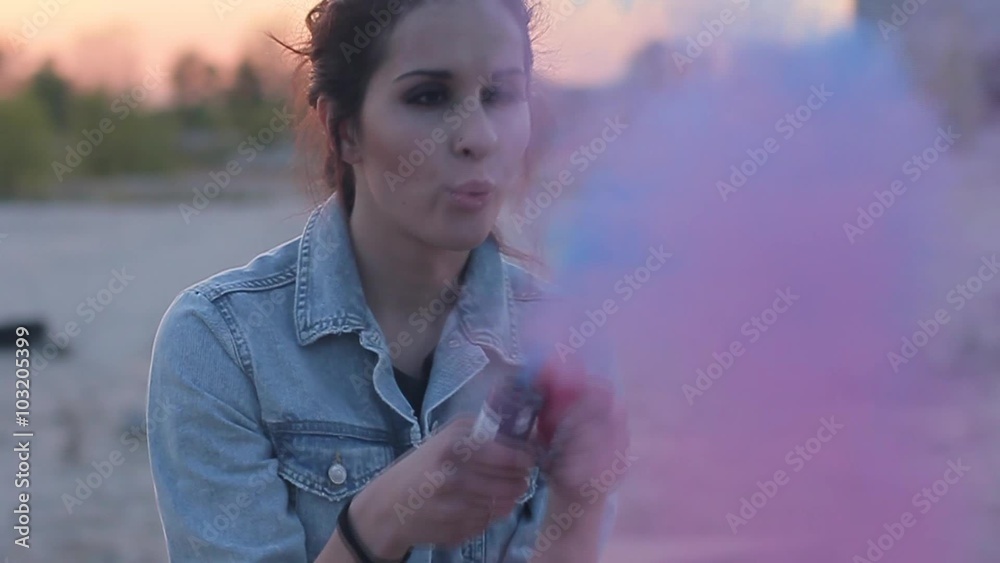 Girl inflates colored smoke bombs. Stock Video Adobe Stock