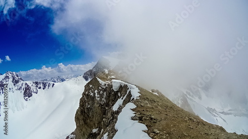 Timelapse.  Cloudy at the top of the ridge mountain Sairam-Su photo