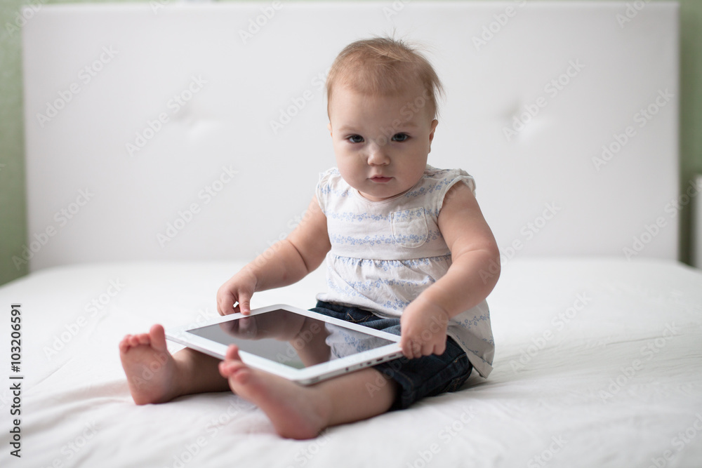 Infant child baby toddler sitting and typing digital tablet comp Infant child baby toddler sitting and typing digital tablet comp