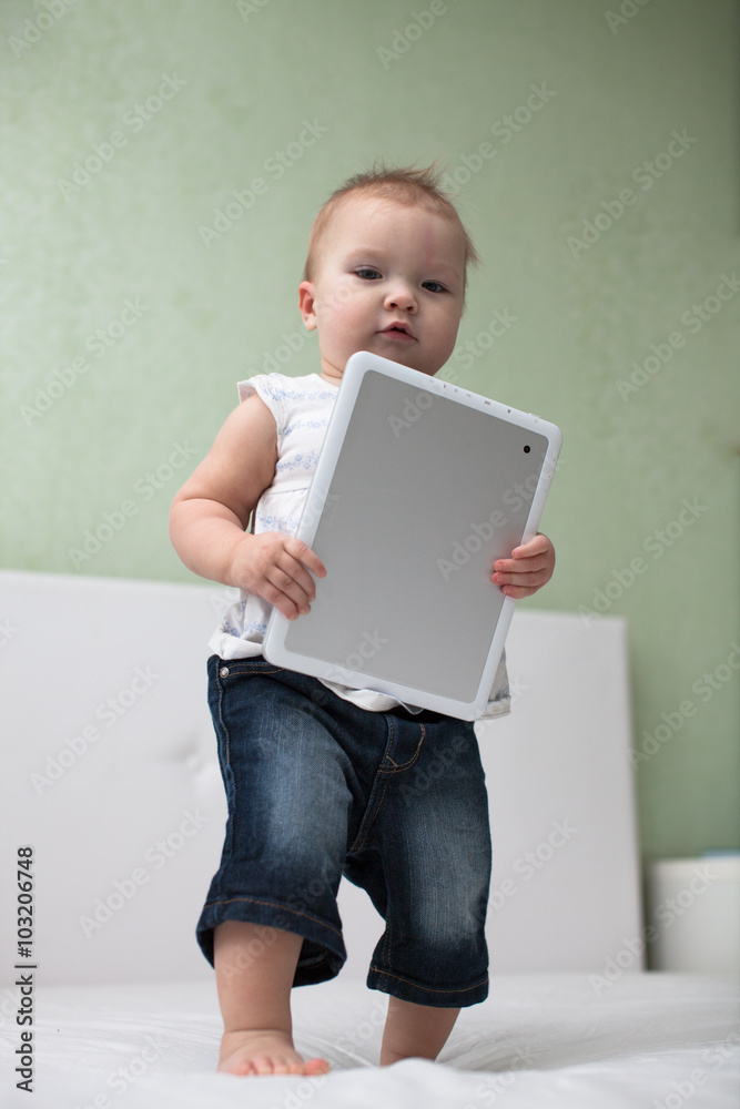 Infant child baby toddler sitting and typing digital tablet comp Infant child baby toddler sitting and typing digital tablet comp