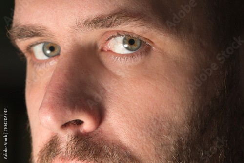 Intimate closeup of a white sexy hot attractive man with mustache beard and hazel eyes looking intense serious thoughtful authentic real beautiful accusatory