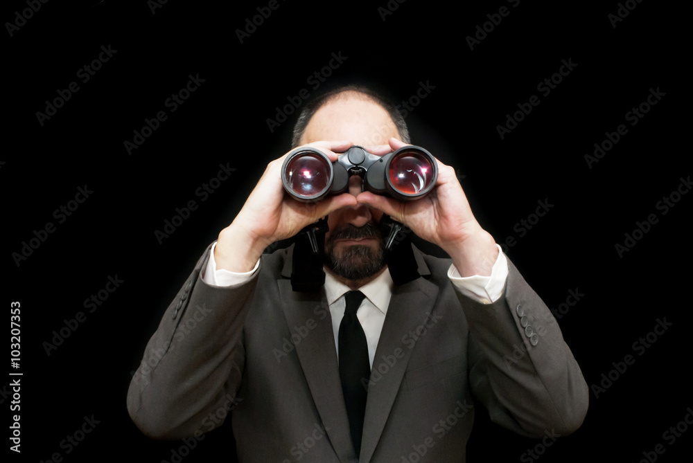 Handsome business man, bald and bearad, looking through binocula Handsome business man, bald and bearad, looking through binocula