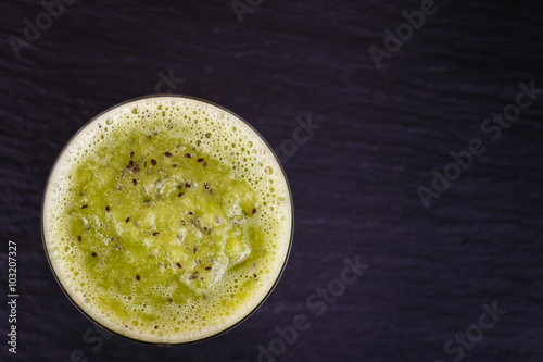 Kiwi smoothie with fresh fruits. Empty space for text.