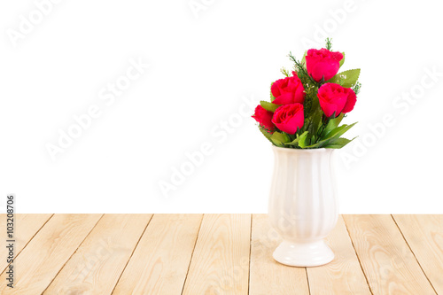 Red roses in pot on wood texture isolated on white background