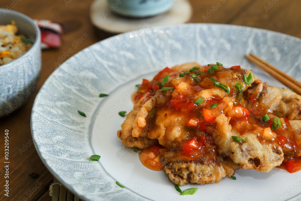 Sweet and sour chicken with rice on a plate