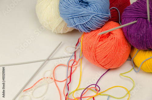 Balls of colored yarn, knitting needles
