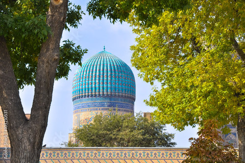 Traditional uzbek dome framed by autumn trees