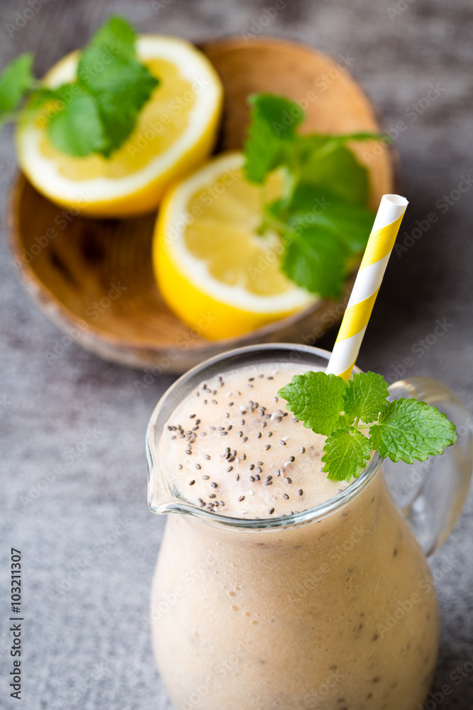 Banana and lemon smoothie, on the grey background. Banana and lemon smoothie, on the grey background.