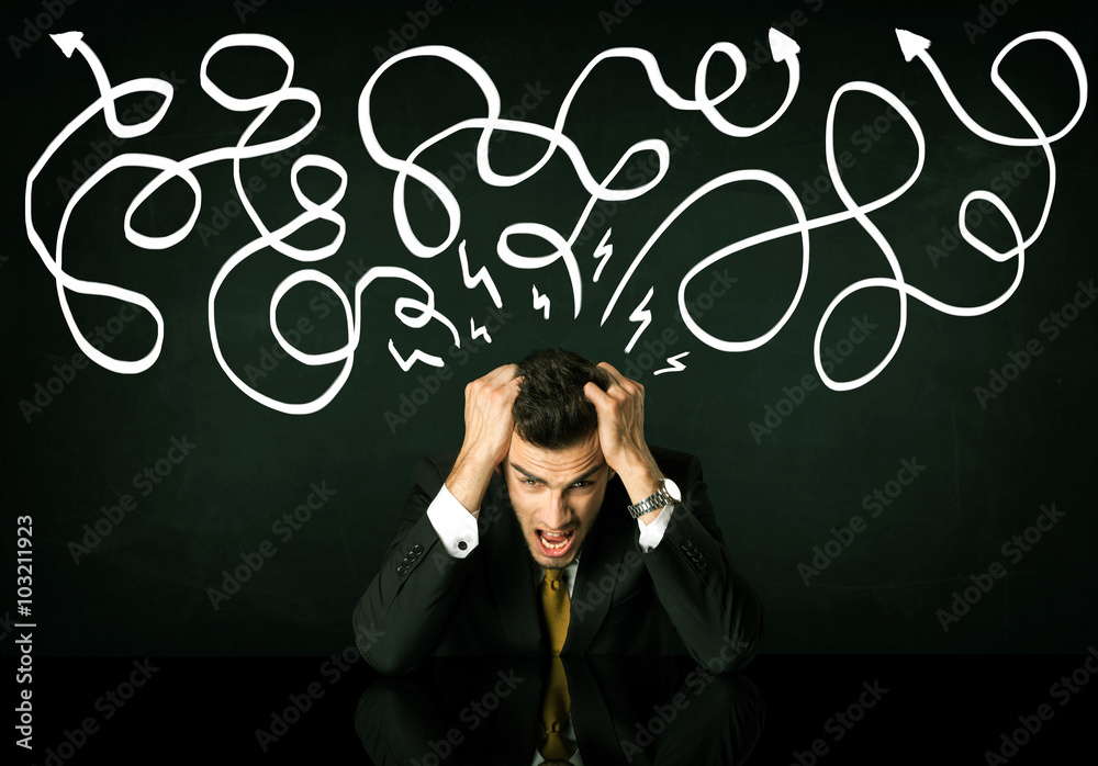 Depressed businessman sitting under drawn direction lines