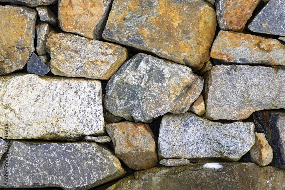 Granite stone wall with colorful stones
