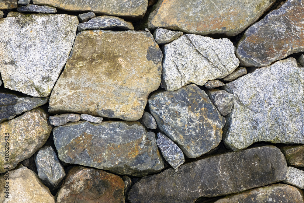 Granite stone wall with colorful stones