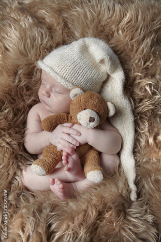 sleeping baby and teddy
