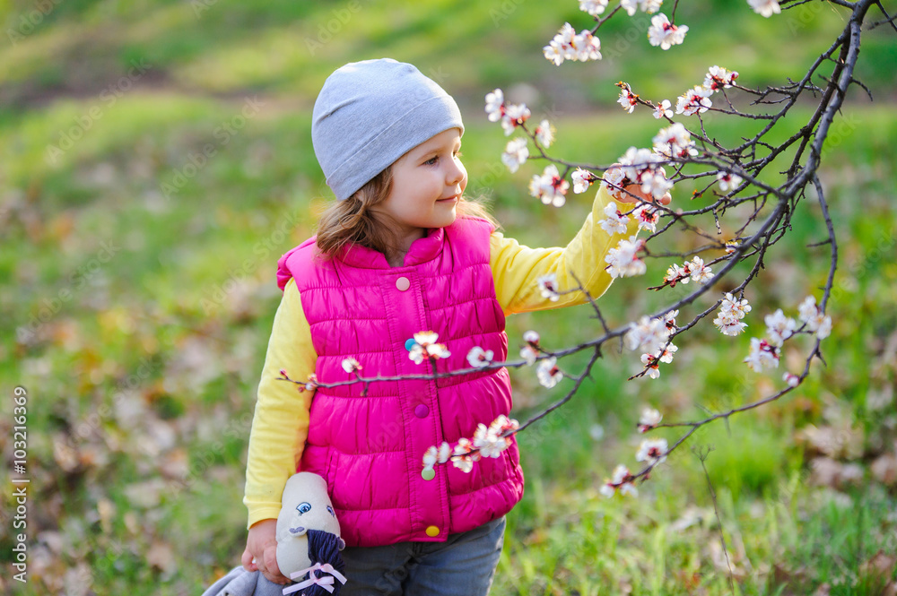 Cute little girl in a blossoming spring garden Cute little girl in a blossoming spring garden