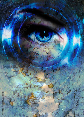 Woman eye and cosmic space, with light circle and desert crackle.