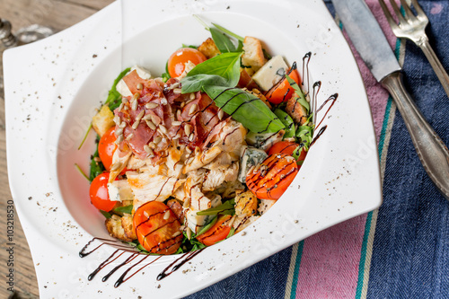 Tasty grilled chicken salad with rucola, cherry tomatoes, valeri photo