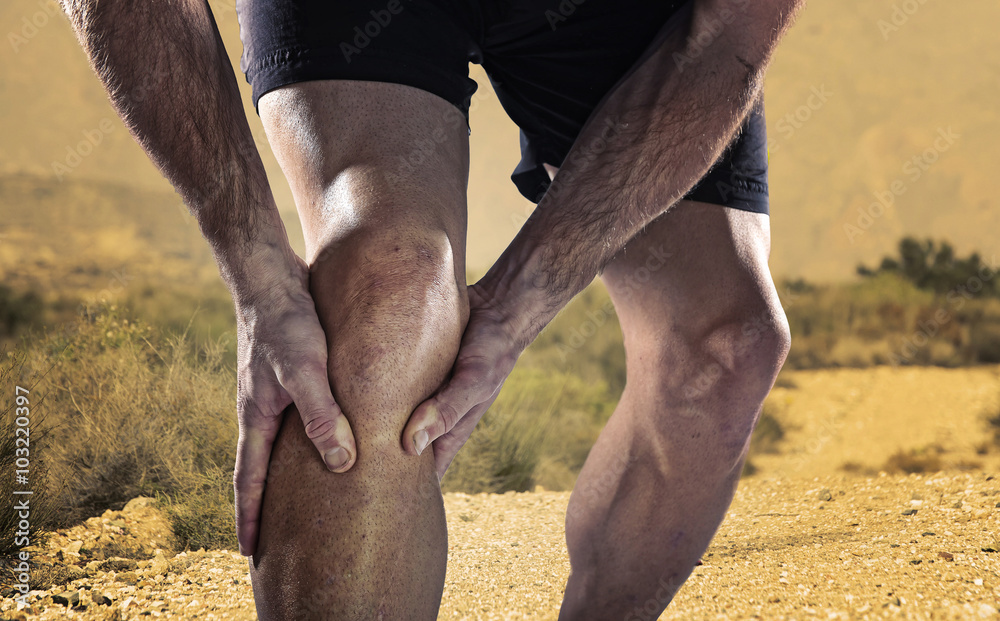 Φωτογραφία young sport man with athletic legs holding knee in pain suffering muscle injury