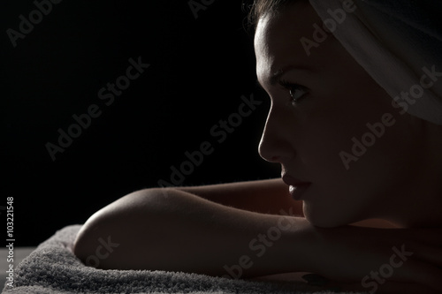 Profile of a beautiful young woman with a towel on her head