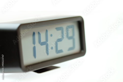 Digital Clock black on white table with selective focus