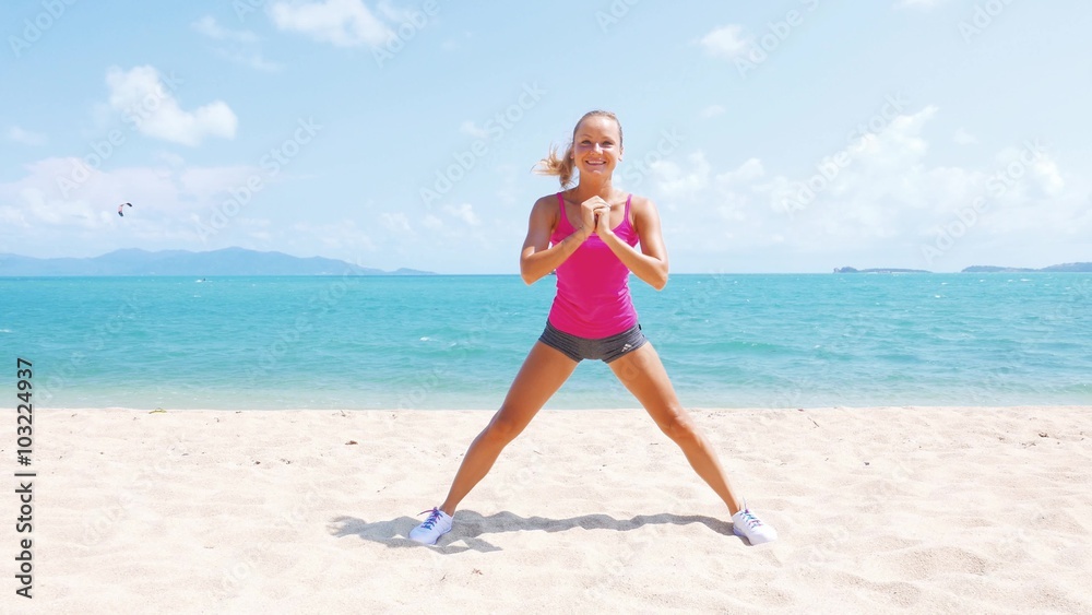 Fitness sport woman doing sporty exercise on beach outside at sunset. Healthy lifestyle image of beautiful young asian woman jogging on black sand beach. Fitness sport woman doing sporty exercise on beach outside at sunset. Healthy lifestyle image of beautiful young asian woman jogging on black sand beach.