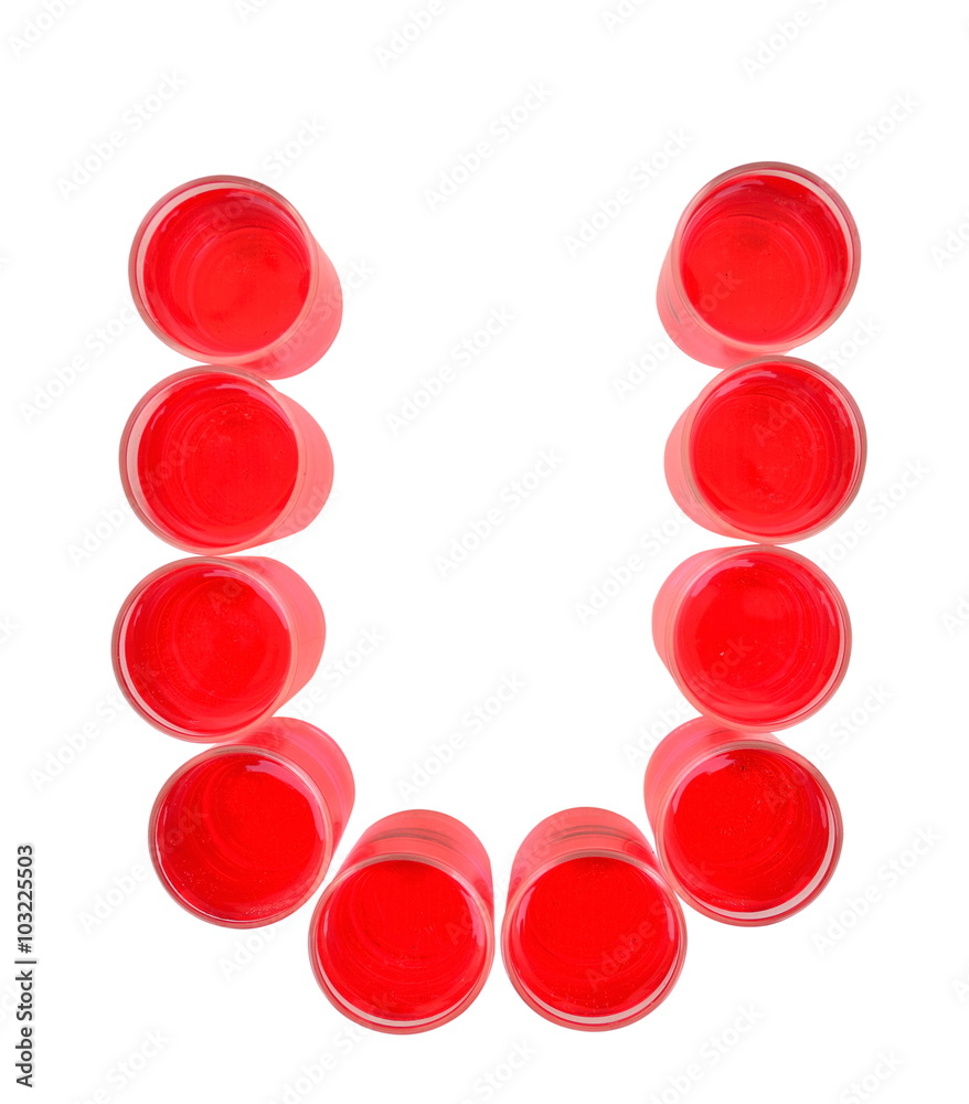 One letter of the alphabet. red drink in a glass One letter of the alphabet. red drink in a glass