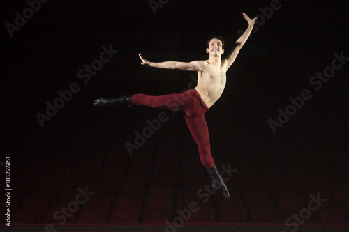 Ballet dancer jumping high, in air.