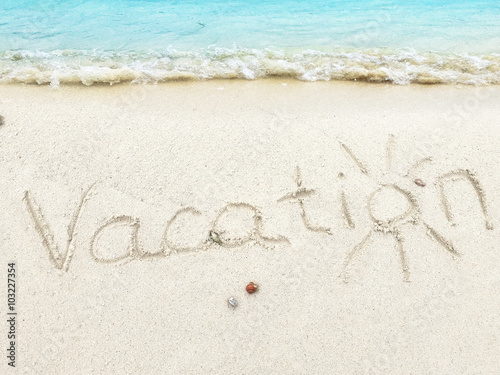 Inscription " Vacations" in the sand on a tropical island, Mald