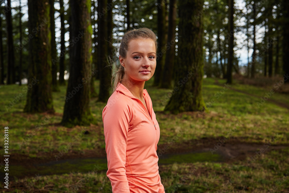 girl looking at camera in forest before run girl looking at camera in forest before run