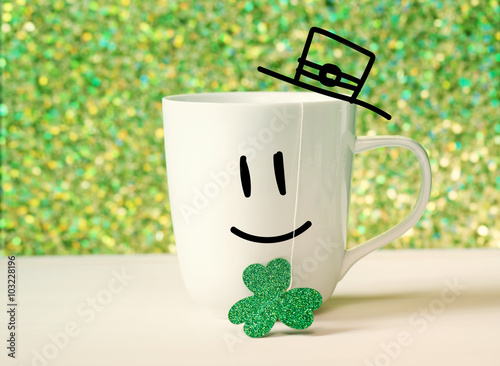 Green clover with happy face on white mug