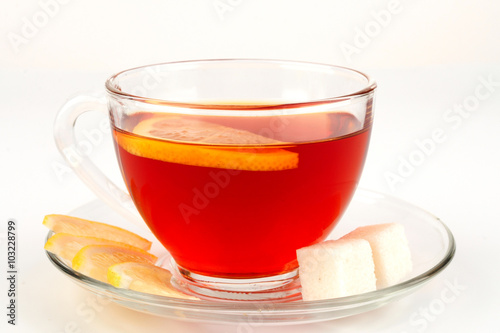 Glass bowl full of tea with pieces of white sugar