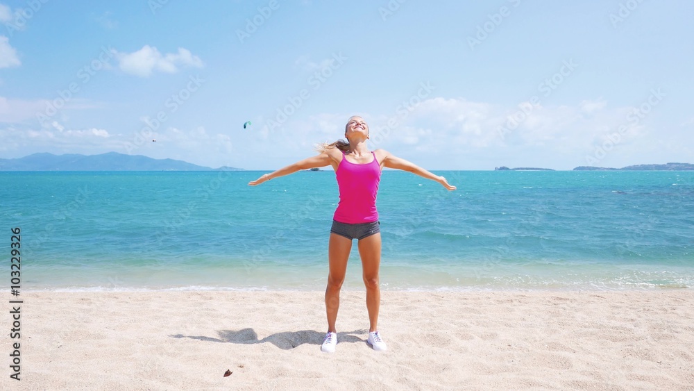 Fitness sport woman doing sporty exercise on beach outside at sunset. Healthy lifestyle image of beautiful young asian woman jogging on black sand beach. Fitness sport woman doing sporty exercise on beach outside at sunset. Healthy lifestyle image of beautiful young asian woman jogging on black sand beach.