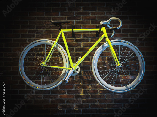Bicycle hanging on brick wall