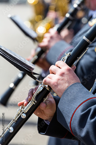 musicians in military orchestra playing on clarinet
