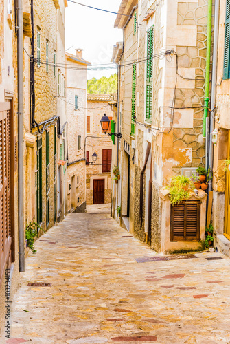 View of a alleyway of a old spanish village with rustic houses 