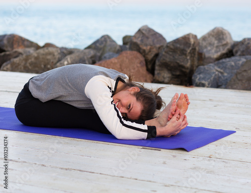 Sportive woman practicing yoga