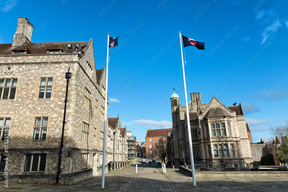 Pair of flags in front of British buildings