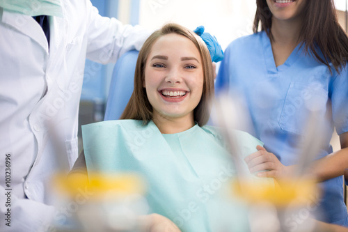 Happy girl in dental chair when pain stopped