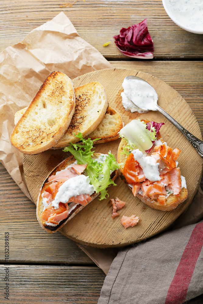 bruschetta with sauce and salmon on board bruschetta with sauce and salmon on board