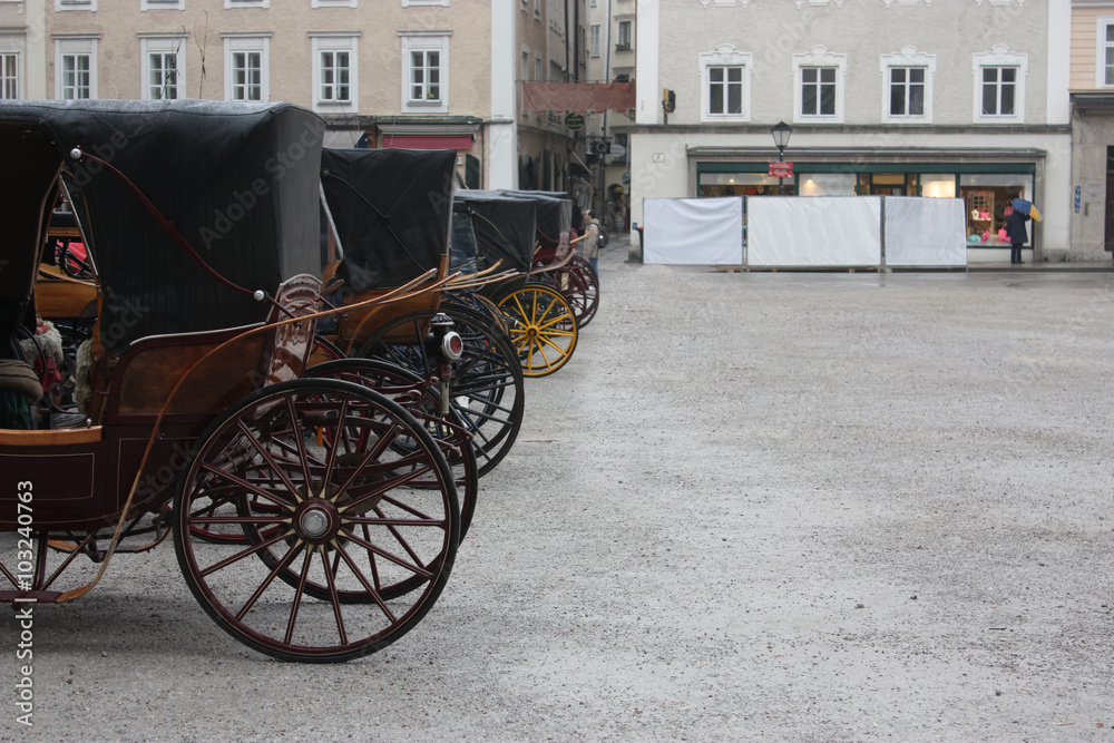 Many carriages on the street.
