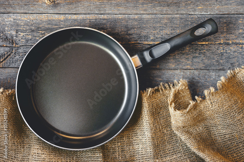 An empty pan on a wooden table