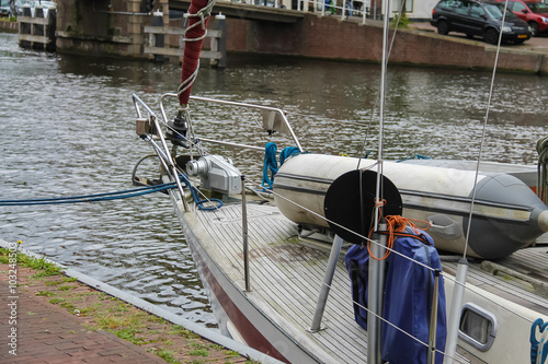 Anchored yacht in Spaarne river channel of Haarlem, the Netherla photo