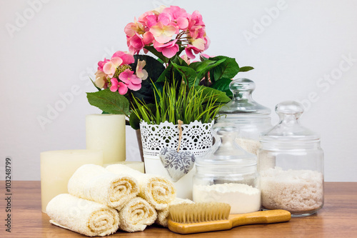 Bath accessories. Personal hygiene items. Bathroom setting. Composition of cosmetic bottles  soap  towel  bath salts and brush. Care for personal hygiene concept. Spa composition.