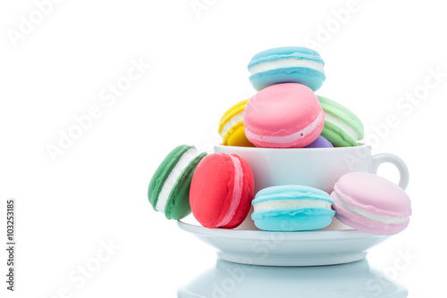French colorful macarons stacks in coffee cup