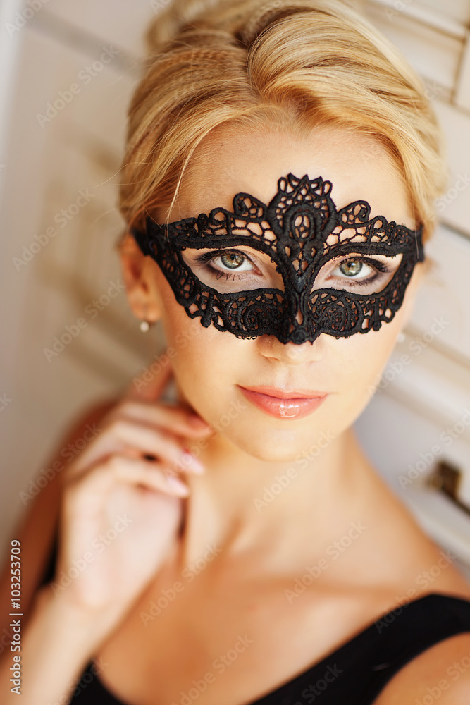Beautiful Woman with Black Lace mask over her Eyes. Blond sensua Beautiful Woman with Black Lace mask over her Eyes. Blond sensua
