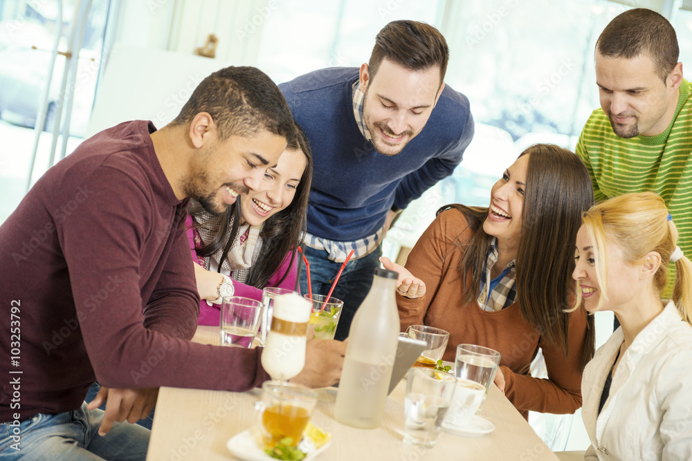 Friends smiling and sitting in a cafe