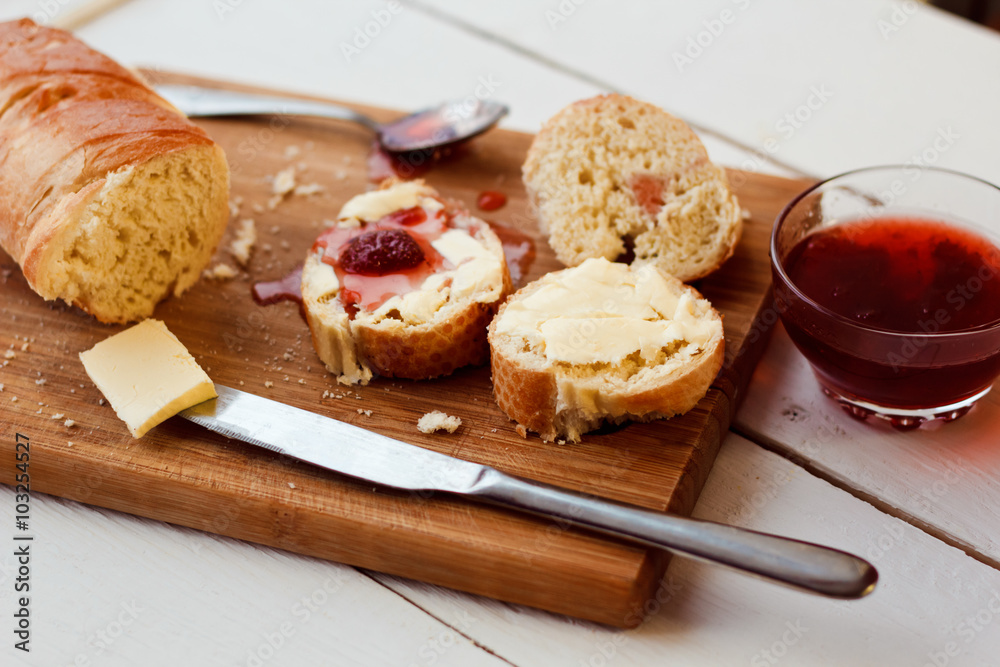 Toasts with jam on plate and cup of tea on bright background Toasts with jam on plate and cup of tea on bright background