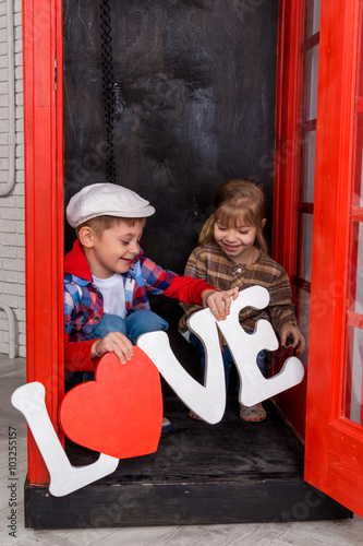 boy and girl in the phone booth
