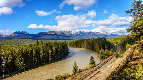 The railroad following Morant's Curve in the Bow River with Haddo Peak, Saddle Mountain and Fairview Mountain in the background in Banff National Park, Alberta, Canada