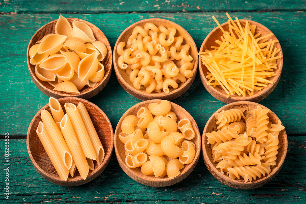 Various mix of pasta on wooden rustic background. Diet and food Various mix of pasta on wooden rustic background. Diet and food