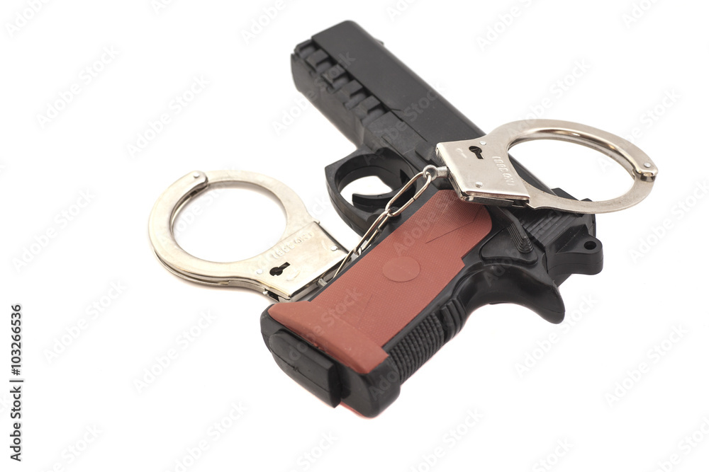 Gun and handcuffs isolated on white background